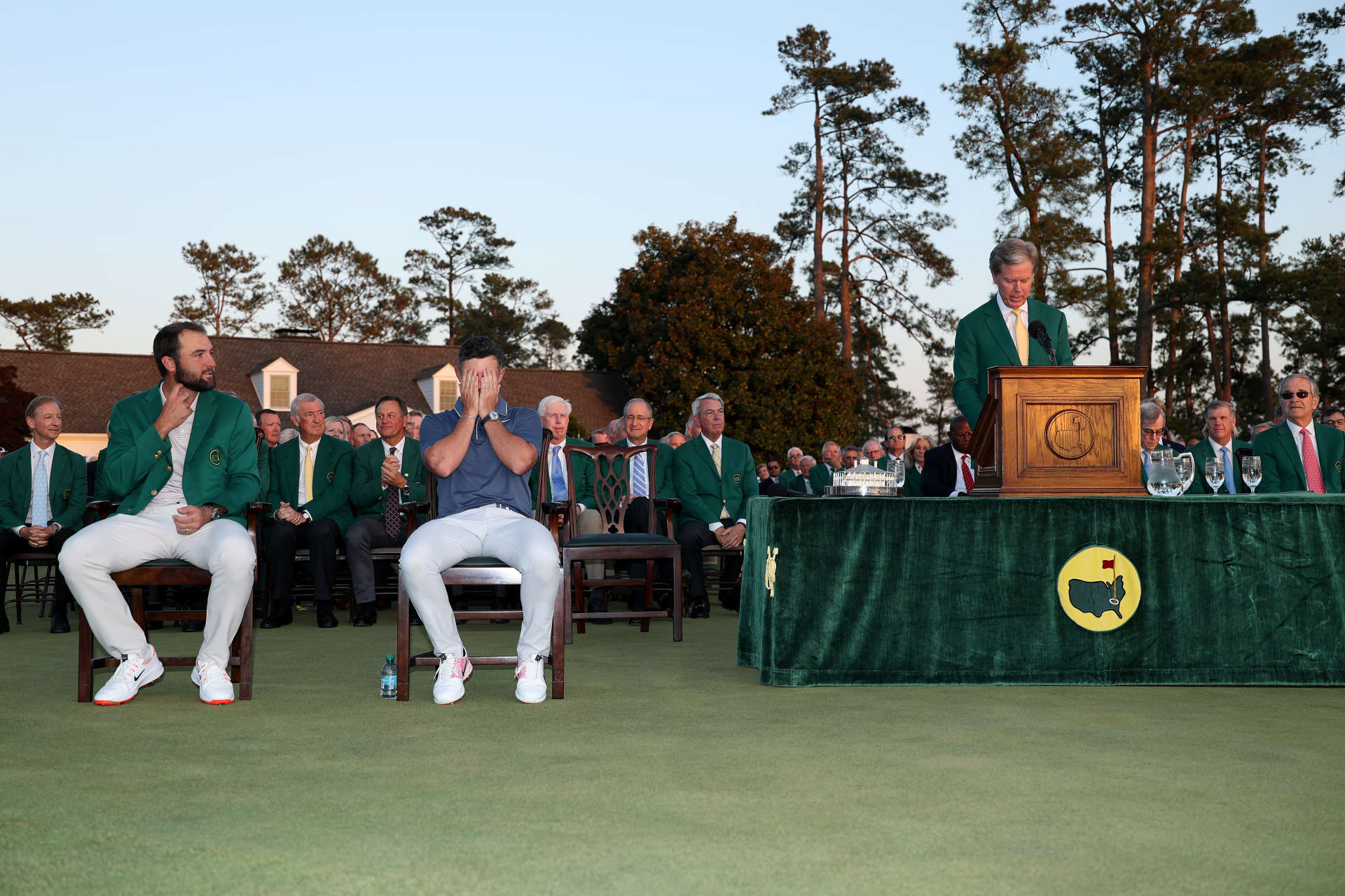 AUGUSTA, GEORGIA - APRIL 13: (R-L) Augusta National Chairman Fred Ridley speaks as Rory McIlroy of Northern Ireland and Scottie Scheffler of the United States react during the Green Jacket Ceremony after the 2025 Masters Tournament at Augusta National Golf Club on April 13, 2025 in Augusta, Georgia. (Photo by Richard Heathcote/Getty Images)