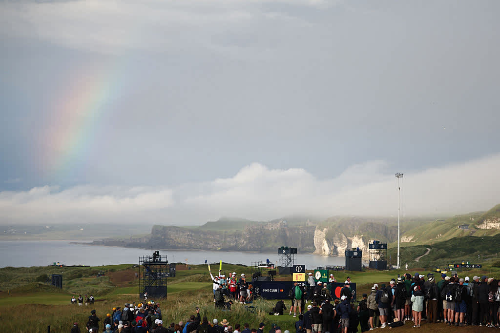 A rainbow appears in the sky as US golfer Scottie Scheffler plays from the 17th tee on day two of the 153rd Open Championship at Royal Portrush golf club in Northern Ireland on July 18, 2025. (Photo by HENRY NICHOLLS / AFP) / RESTRICTED TO EDITORIAL USE (Photo by HENRY NICHOLLS/AFP via Getty Images)