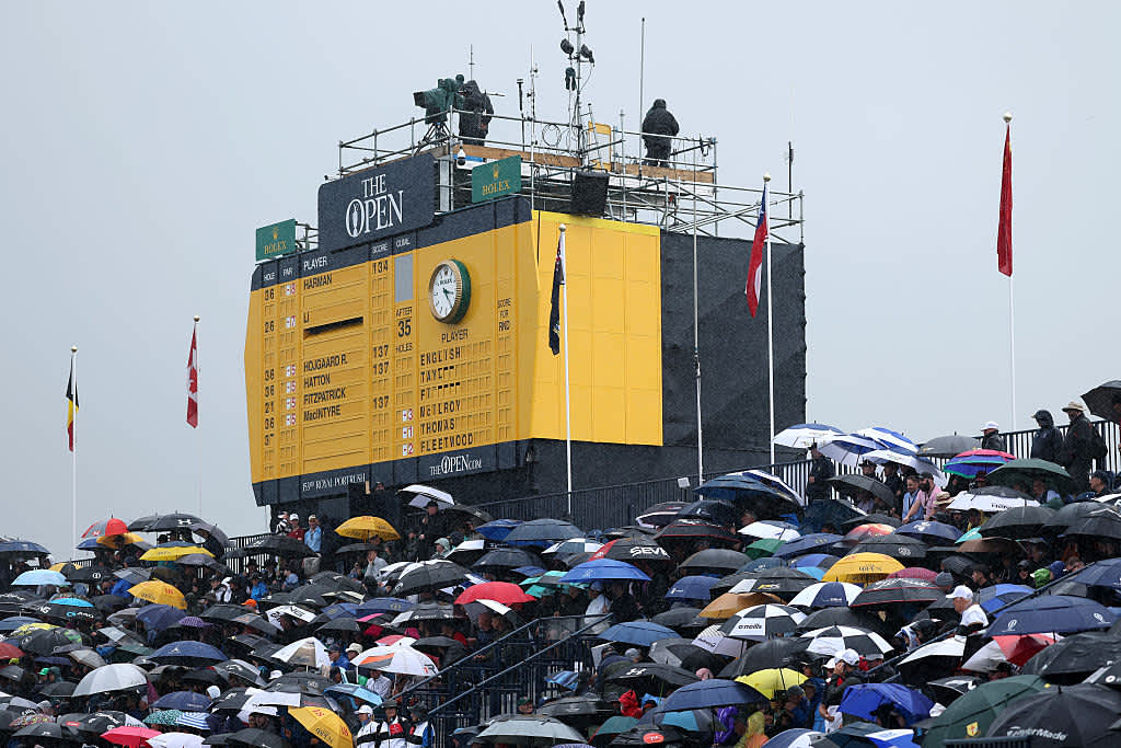 PORTRUSH, NORTHERN IRELAND - JULY 18: Spectators hold umbrellas in the rain during day two of The 153rd Open Championship at Royal Portrush Golf Club on July 18, 2025 in Portrush, Northern Ireland. (Photo by Christian Petersen/Getty Images)