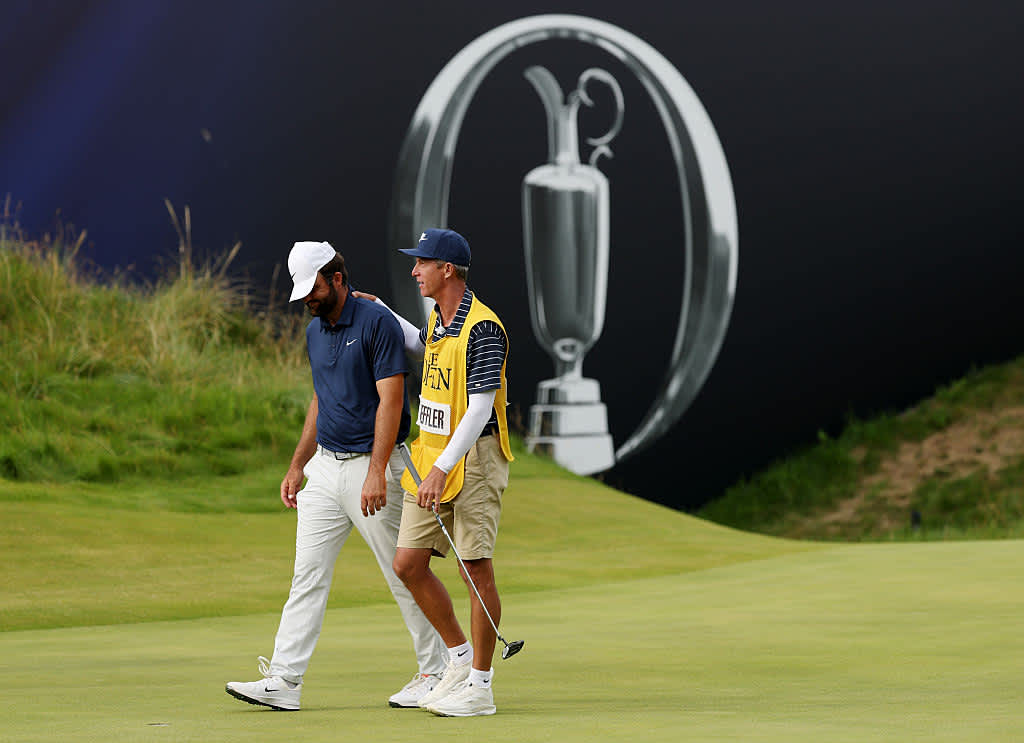 PORTRUSH, NORTHERN IRELAND - JULY 20: Scottie Scheffler of the United States celebrates with his caddie Ted Scott on the 18th green after winning The 153rd Open Championship at Royal Portrush Golf Club on July 20, 2025 in Portrush, Northern Ireland. (Photo by Richard Heathcote/Getty Images)