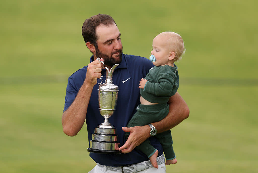 PORTRUSH, NORTHERN IRELAND - JULY 20: Scottie Scheffler of the United States celebrates with his son Bennett Scheffler and the Claret Jug on the 18th green after winning The 153rd Open Championship at Royal Portrush Golf Club on July 20, 2025 in Portrush, Northern Ireland. (Photo by Andrew Redington/Getty Images)