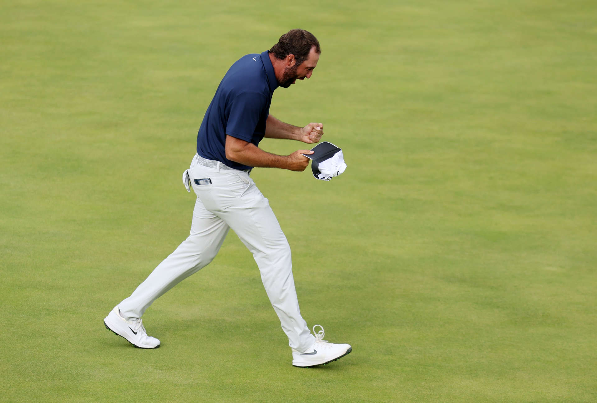 PORTRUSH, NORTHERN IRELAND - JULY 20: Scottie Scheffler of the United States celebrates on the 18th green after winning The 153rd Open Championship at Royal Portrush Golf Club on July 20, 2025 in Portrush, Northern Ireland. (Photo by Andrew Redington/Getty Images)