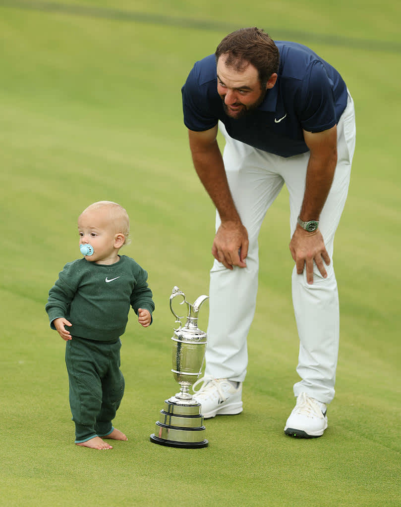 PORTRUSH, NORTHERN IRELAND - JULY 20: Scottie Scheffler of the United States celebrates with his son Bennett Scheffler and the Claret Jug on the 18th green after winning The 153rd Open Championship at Royal Portrush Golf Club on July 20, 2025 in Portrush, Northern Ireland. (Photo by Luke Walker/Getty Images for HSBC)