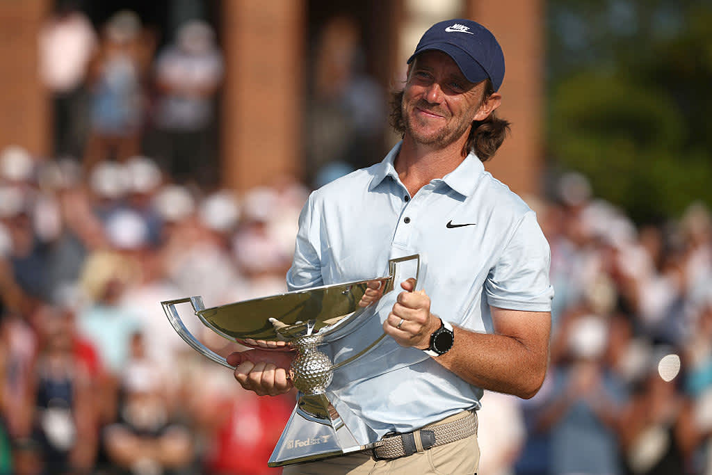 ATLANTA, GEORGIA - AUGUST 24: Tommy Fleetwood of England celebrates with the Fedex Cup trophy after winning the final round of the TOUR Championship 2025 at East Lake Golf Club on August 24, 2025 in Atlanta, Georgia. (Photo by Jared C. Tilton/Getty Images)