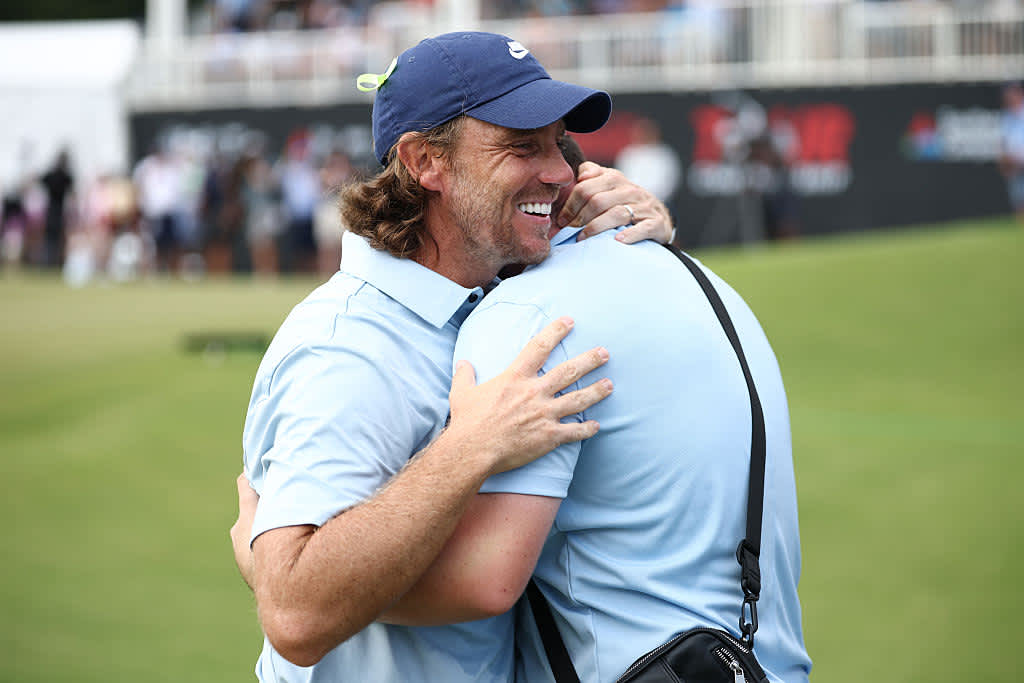 ATLANTA, GEORGIA - AUGUST 24: Tommy Fleetwood of England and his stepson, Oscar Craig, embrace on the 18th green after winning the final round of the TOUR Championship 2025 at East Lake Golf Club on August 24, 2025 in Atlanta, Georgia. (Photo by Jared C. Tilton/Getty Images)