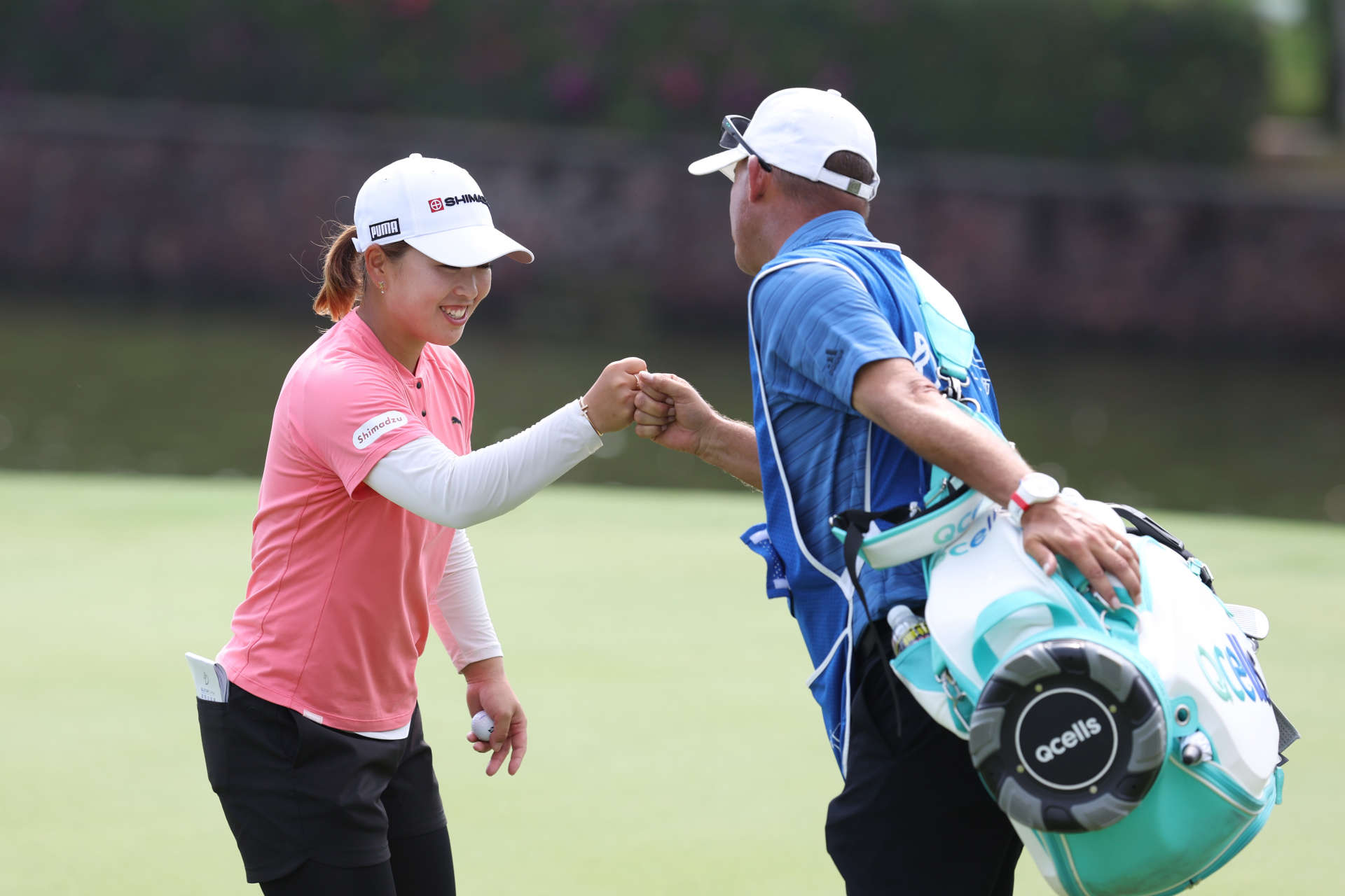 HAINAN ISLAND, CHINA - MARCH 10: Mao Saigo of Japan bumps fists with her caddie on 18th hole during the final round of the Blue Bay LPGA at Jian Lake Blue Bay Golf Course on March 10, 2024 in Hainan Island, Hainan. (Photo by Zhizhao Wu/Getty Images)