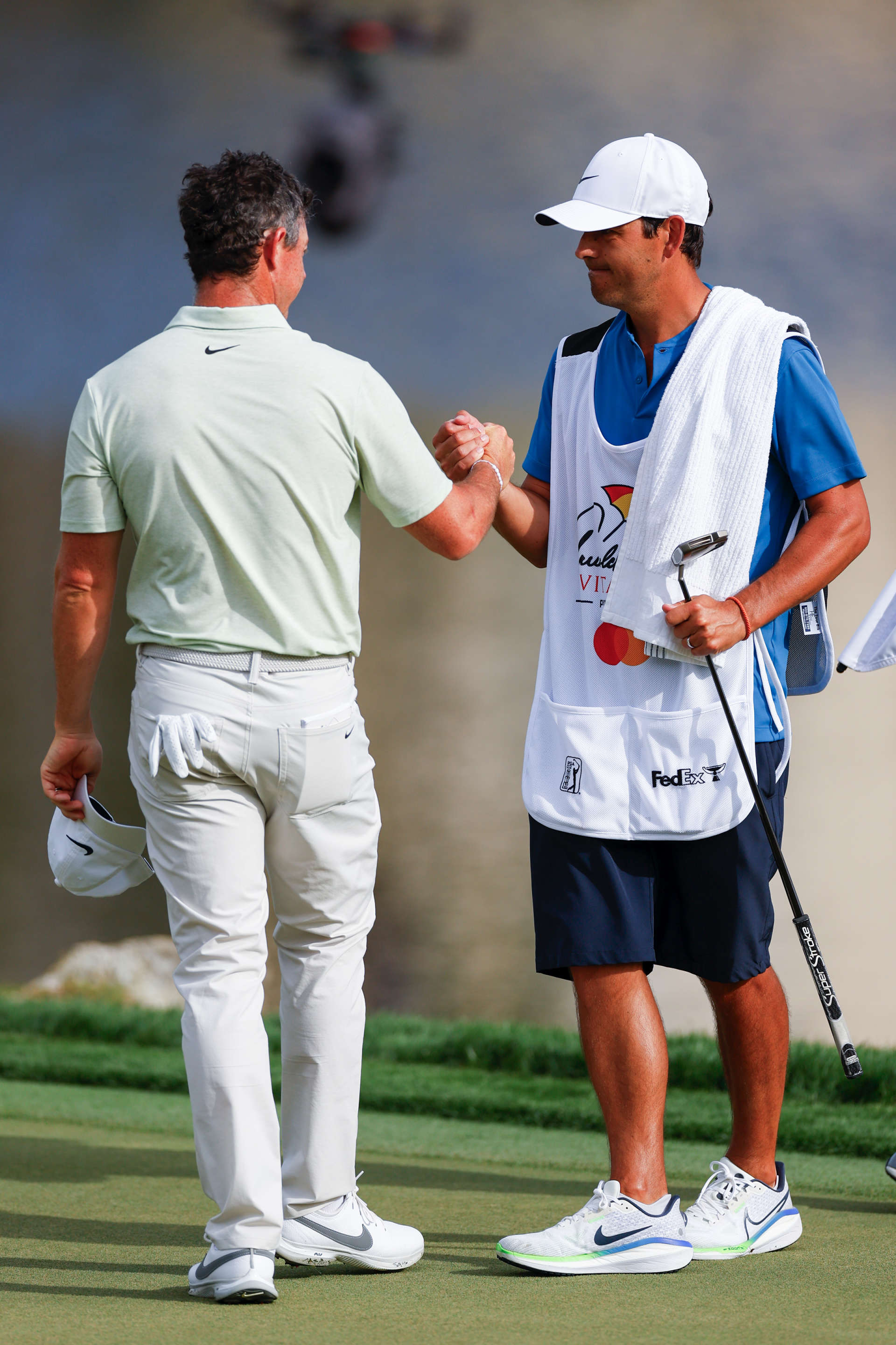 ORLANDO, FLORIDA - MARCH 10: Rory McIlroy of Northern Ireland shakes hands with his caddie Harry Diamond on the 18th hole green after finishing the final round of the Arnold Palmer Invitational presented by Mastercard at Arnold Palmer Bay Hill Golf Course on March 10, 2024 in Orlando, Florida. (Photo by Mike Ehrmann/Getty Images)
