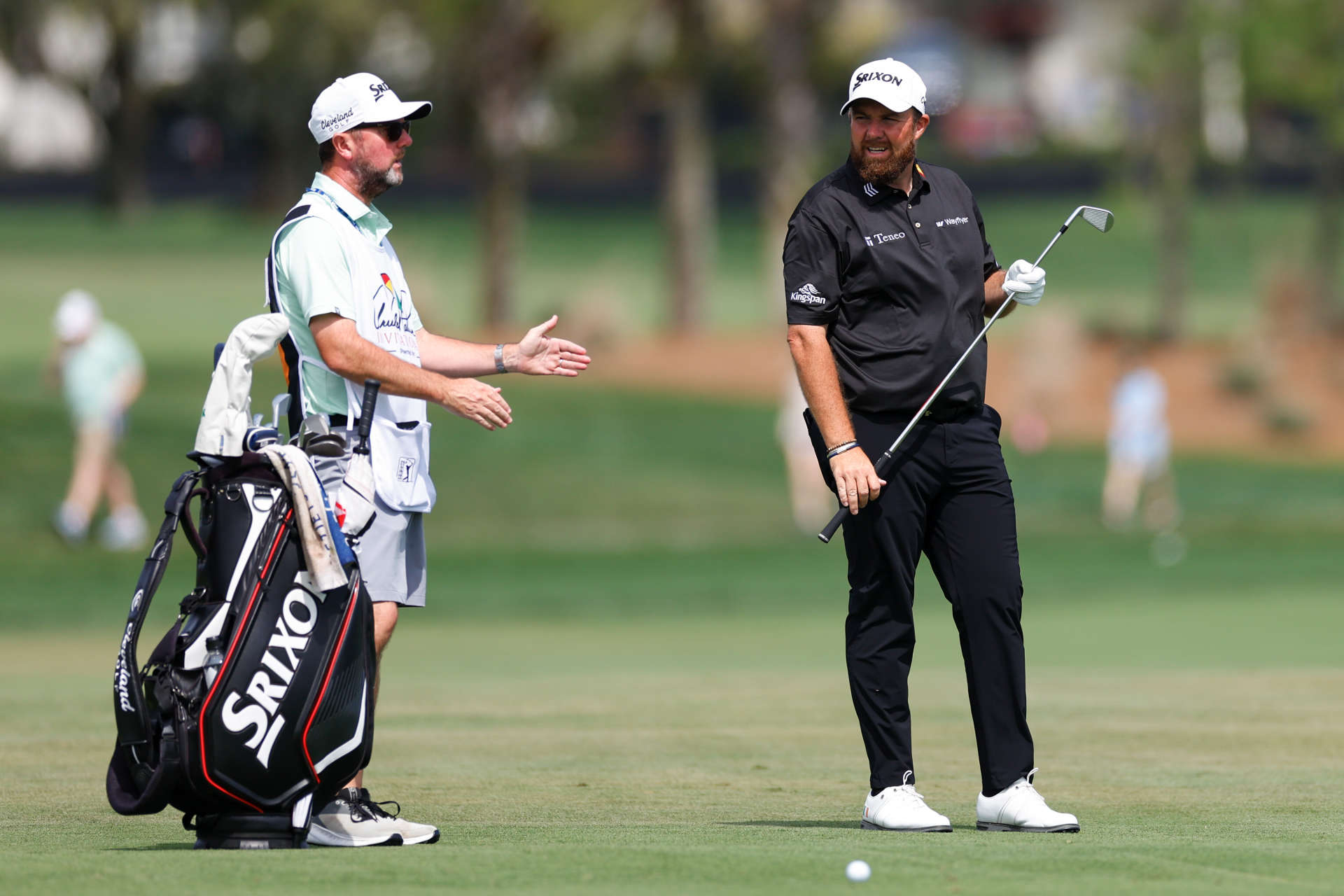 ORLANDO, FLORIDA - MARCH 10: Shane Lowry of Ireland talks with his caddie Darren Reynolds before hitting an approach shot on the sixth hole during the final round of the Arnold Palmer Invitational presented by Mastercard at Arnold Palmer Bay Hill Golf Course on March 10, 2024 in Orlando, Florida. (Photo by Mike Ehrmann/Getty Images)