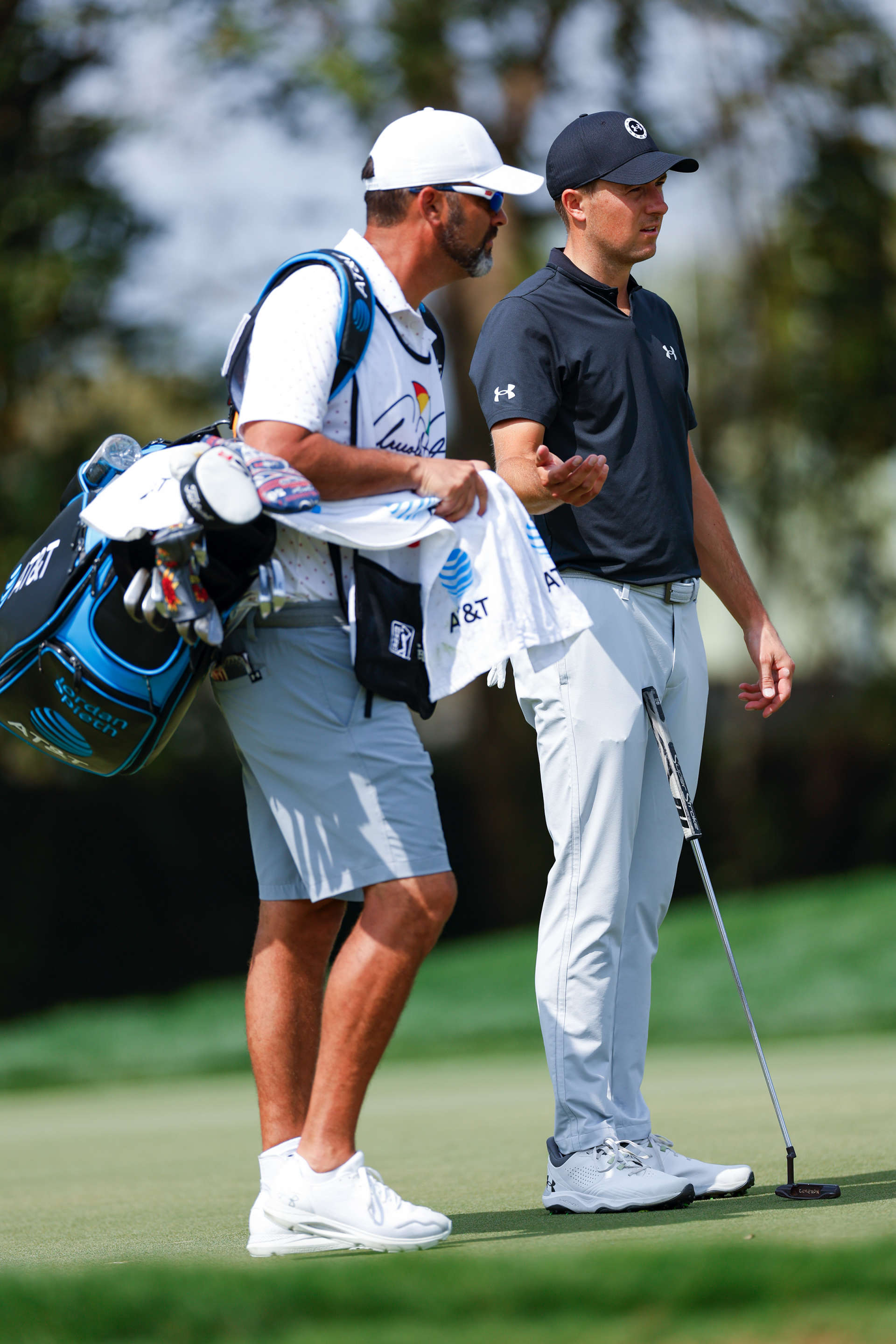 ORLANDO, FLORIDA - MARCH 09: Jordan Spieth of the United States talks with his caddie on the first hole during the third round of the Arnold Palmer Invitational presented by Mastercard at Arnold Palmer Bay Hill Golf Course on March 09, 2024 in Orlando, Florida. (Photo by Mike Ehrmann/Getty Images)