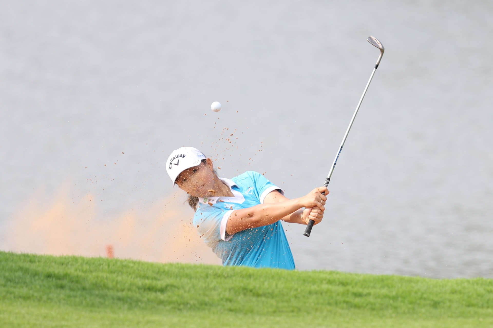 HAINAN ISLAND, CHINA - MARCH 09: Ruoning Yin of China plays a shot from a bunker on 6th hole during the third round of the Blue Bay LPGA at Jian Lake Blue Bay Golf Course on March 09, 2024 in Hainan Island, Hainan. (Photo by Zhizhao Wu/Getty Images)