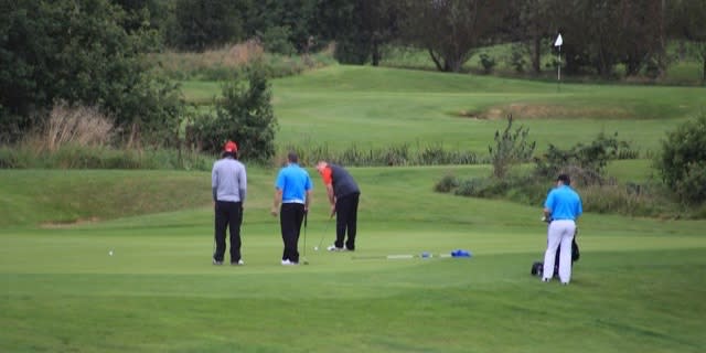 Golfers on putting green