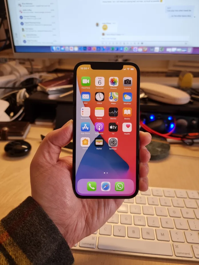 iPhone 12 in hand after booting iPhone 12 in hand after booting