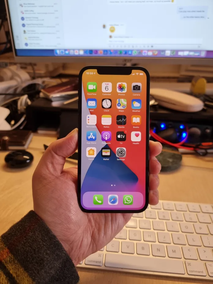 iPhone 12 in hand after booting