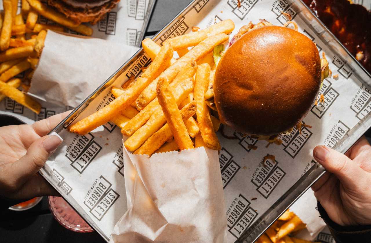 Two burgers and servings of fries at Street Burger.