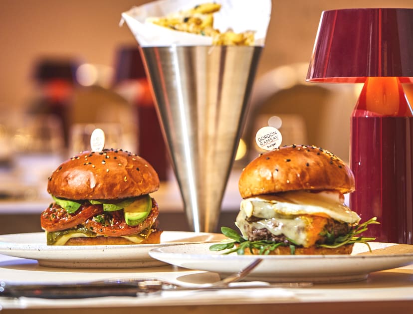 Two burgers on a plate with chips