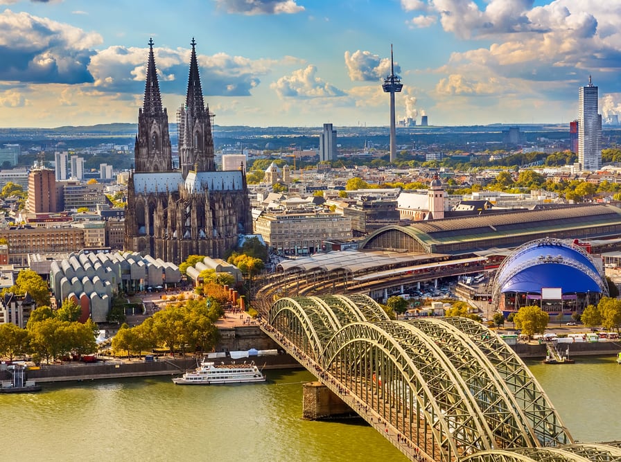 Cologne cathedral next to a bridge across the Rhine