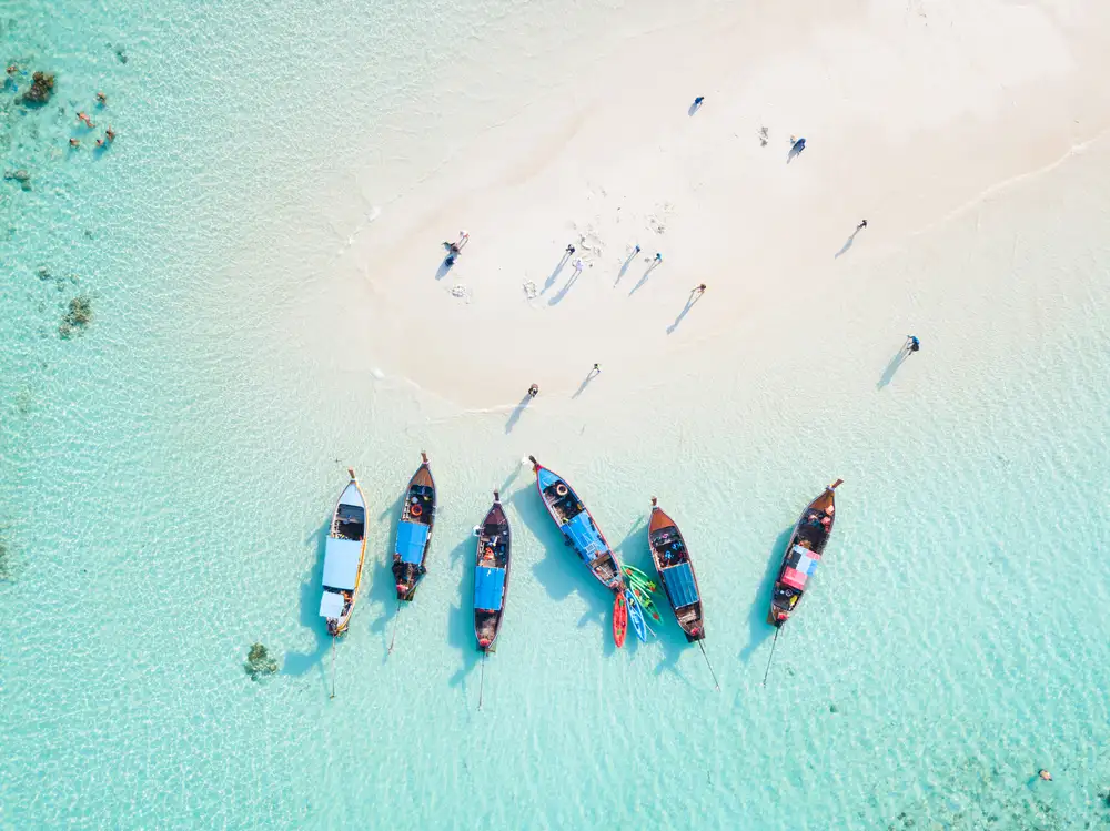 Longtail Boats Rest On a White Sandy Beach Phuket