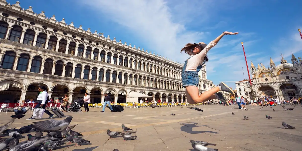 Girl jumping on St. Mark's Square in Venice