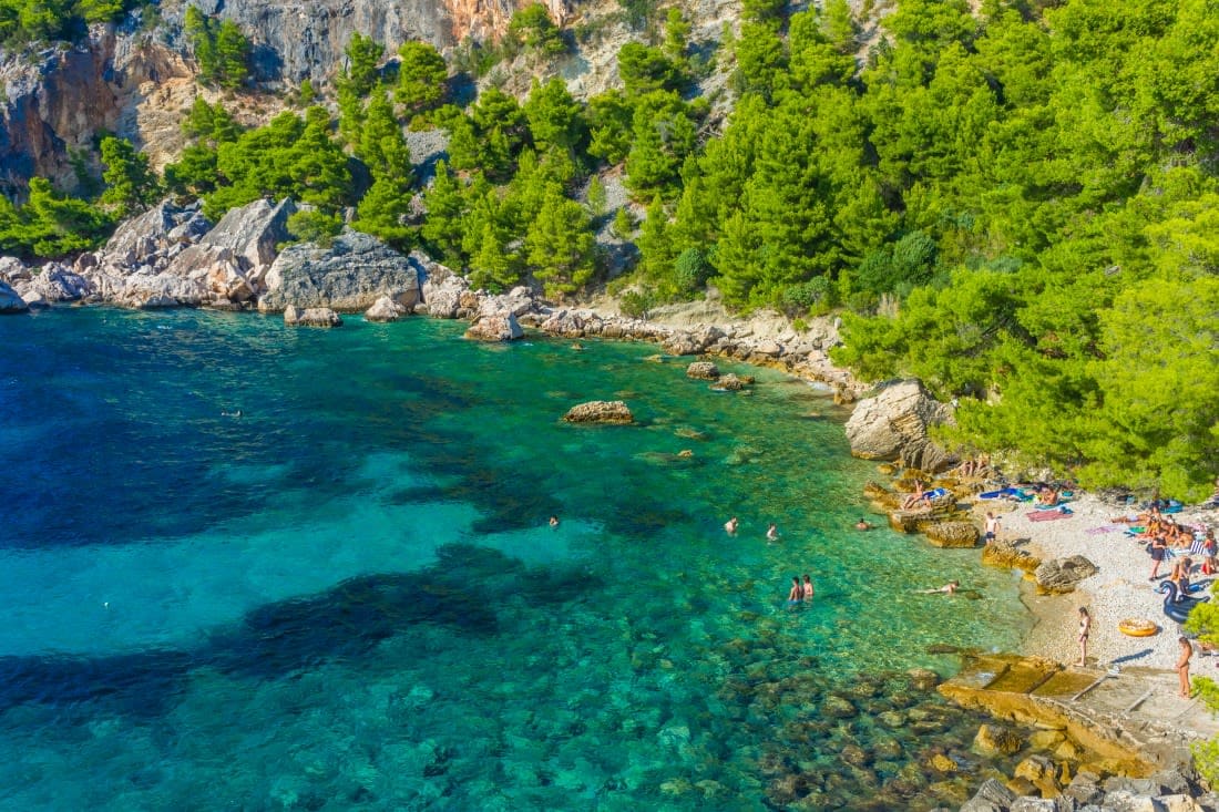 small hidden beach with emerald water
