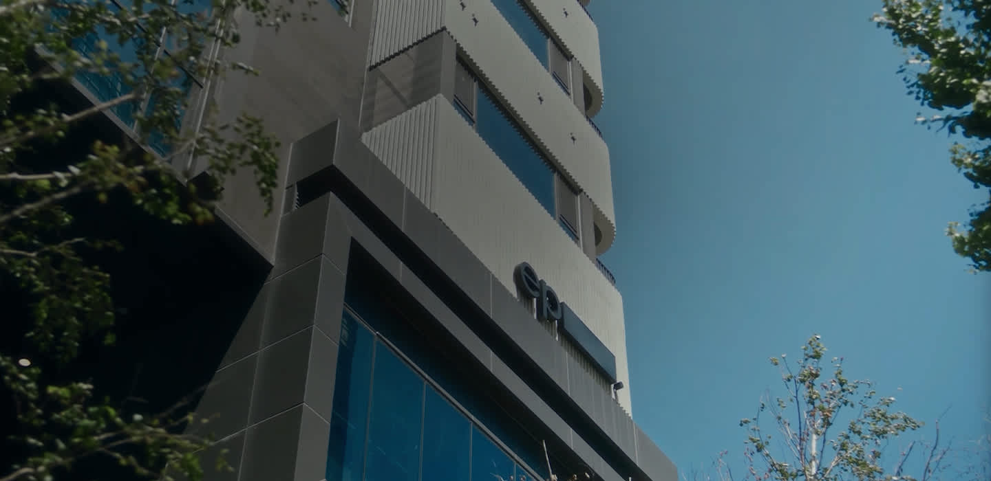 A view of the Episode Yongsan 241 residential building from below looking up at the modern exterior.