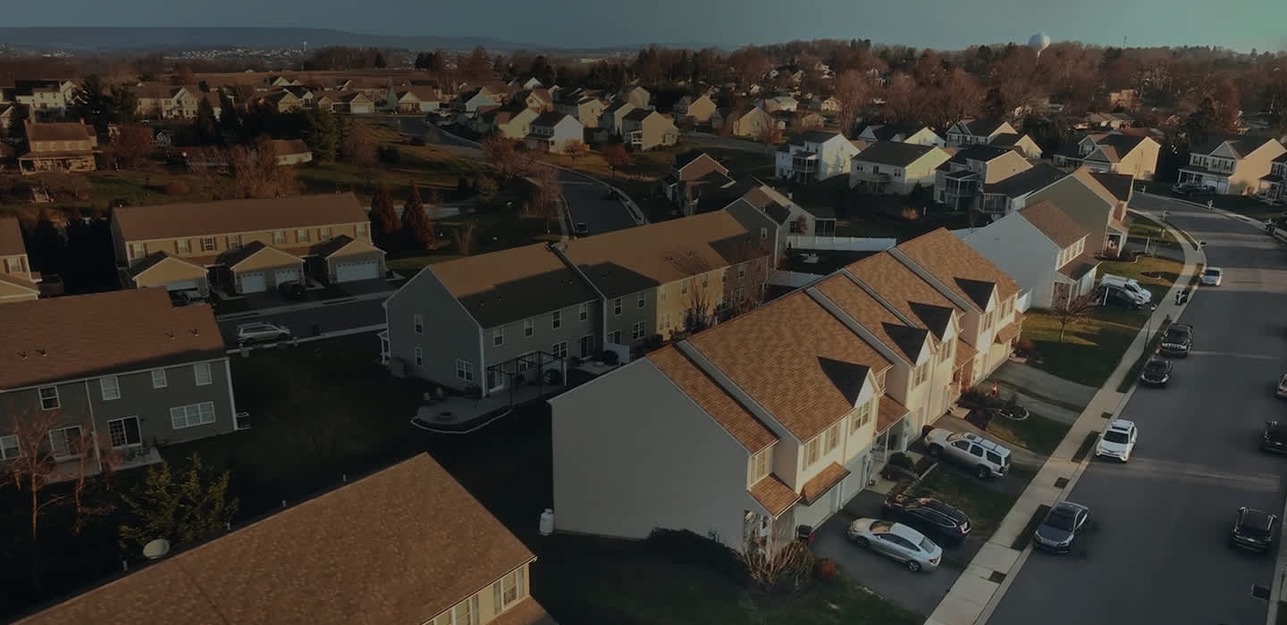 Aerial view of the POSCO Zero Energy House townhouse complex with multiple residential properties lined next to each other.