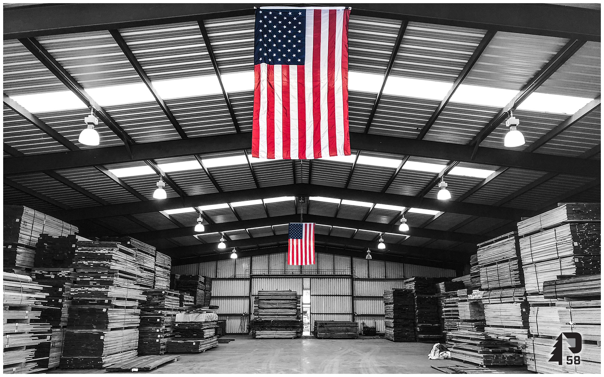 Kiln dried lumber in Texas with American Flags hanging. 
