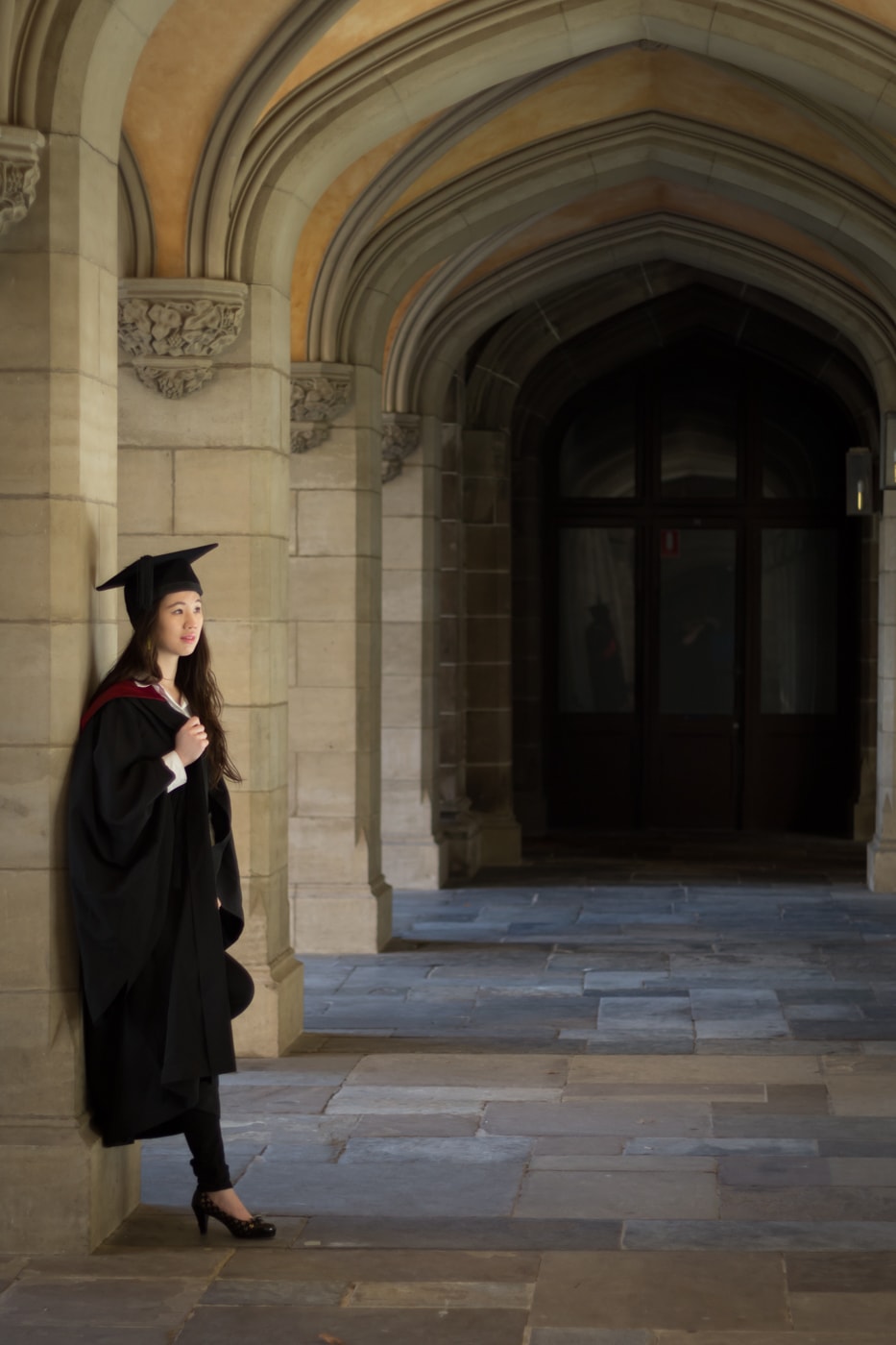 QLD graduate looking to the right in graduation gown set