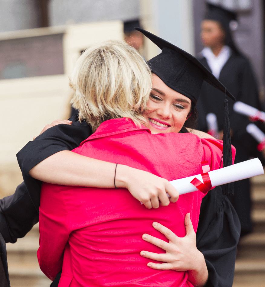 Tasmanian graduate in academic gown hugging mother