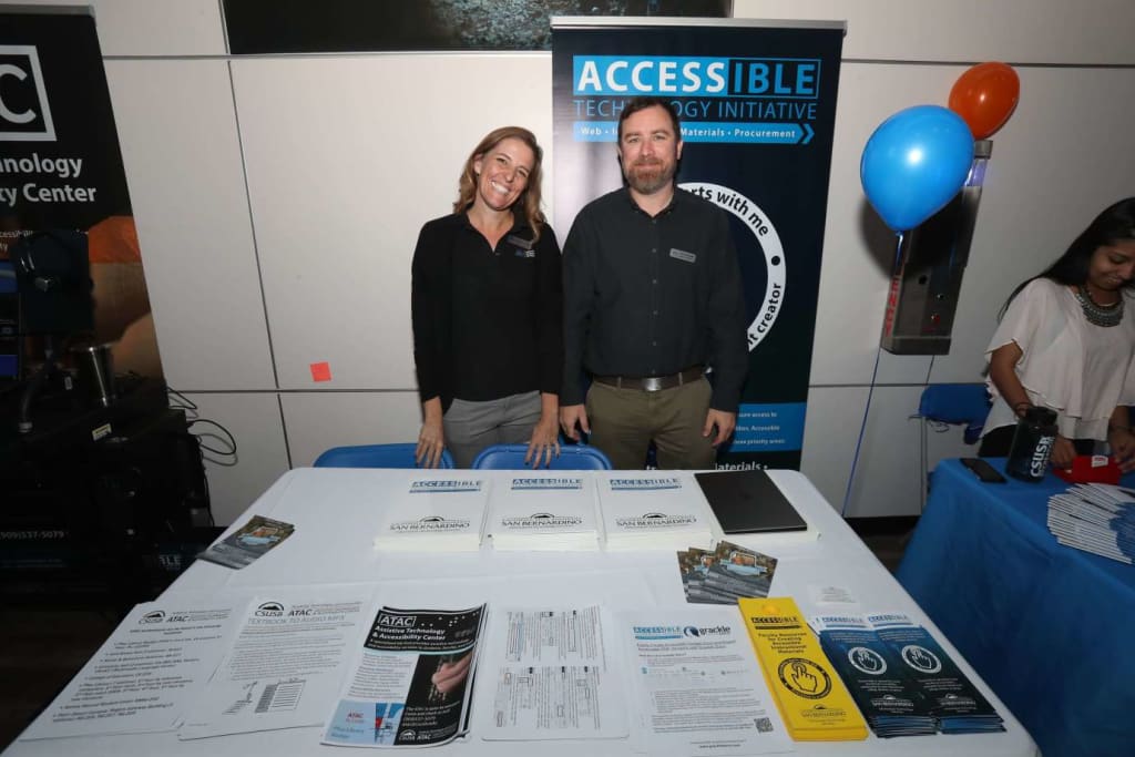 (L to R) Christine Fundell, Accessibility Specialist and Leon McNaught, Accessible Technology Initiative Coordinator at OktoberTech – Tech Days, in “The Cave”, CSUSB