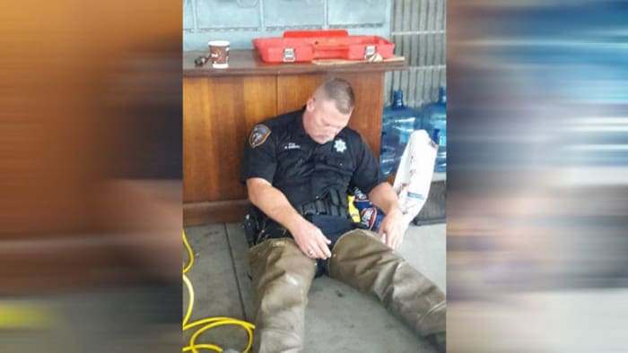 Photo Of Deputy Resting After Spending Hours Rescuing Flood Victims Goes Viral 0842