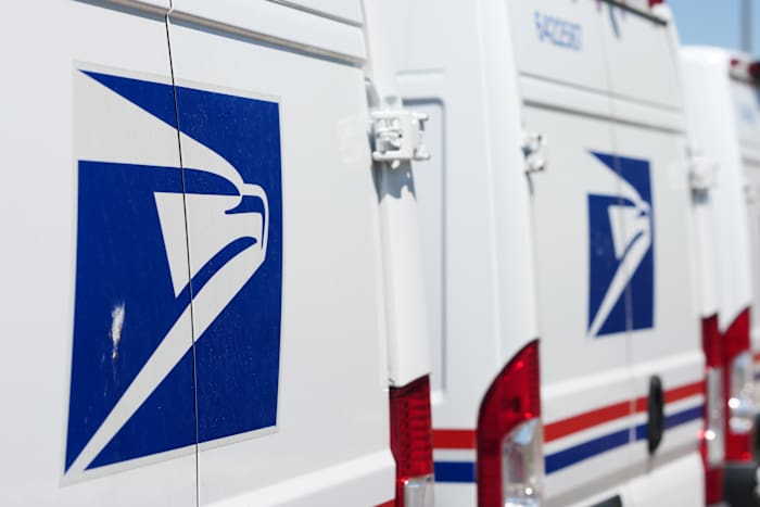 FILE - Delivery vans are parked during a protest staged as part of a countrywide National Day of Action Tuesday, July 28, 2026, outside the main United States Postal Service headquarters in northeast Denver. (AP Photo/David Zalubowski, File)