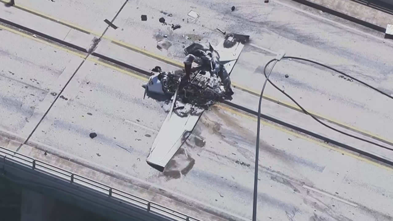 Small plane crashes on bridge near Miami, striking an SUV