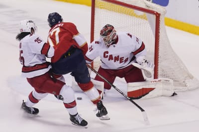 Carolina Hurricanes' Ethan Bear (25) skates with the puck during the first  period of an NHL