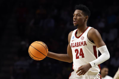 Alabama basketball's Brandon Miller is protected by ARMED SECURITY