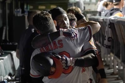 Baltimore Orioles' Jorge Mateo, left, is embraced by Ramon Urias