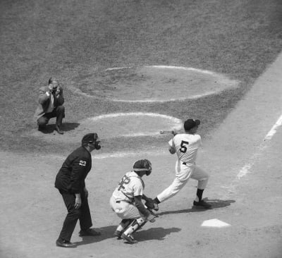 Roy Campanella, catcher for the Brooklyn Dodgers, holding six bats