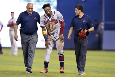 Atlanta Braves left fielder Ronald Acuna Jr. (13) and Braves mascots Blooper  have fun in the dugout before am baseball game against the Miami Marlins  Tuesday, July 31, 2018 in Atlanta. (AP