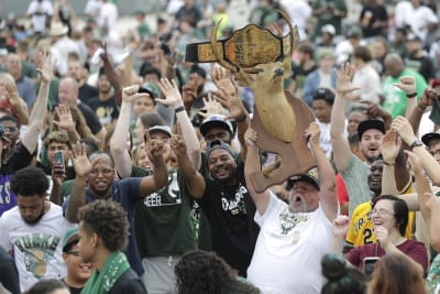 Milwaukee Bucks' Giannis Antetokounmpo holds up the Finals MVP trophy as  confetti falls during a parade celebrating the Milwaukee Bucks' NBA  Championship basketball team Thursday, July 22, 2021, in Milwaukee. (AP  Photo/Aaron