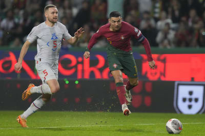 Bruised Ronaldo scores twice to edge showdown with Messi