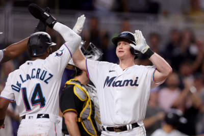 San Diego Padres' Garrett Cooper, right, celebrates with third