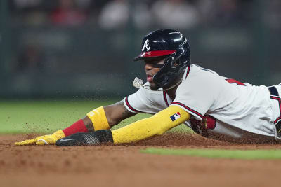 Dansby Swanson of the Chicago Cubs misses the tag on Ronald Acuna Jr.  News Photo - Getty Images