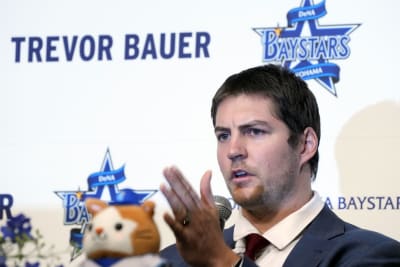 Trevor Bauer puts on his new uniform of Yokohama DeNA BayStars during a  photo session of the news conference Friday, March 24, 2023, in Yokohama,  near Tokyo. (AP Photo/Eugene Hoshiko Stock Photo 