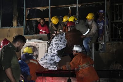 Rescue workers save people from a building fire in Pakistan