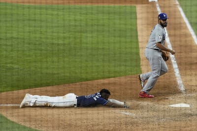 Photos: Randy Arozarena lays on home plate after game-winning run