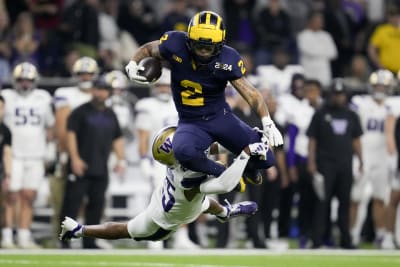 Michigan overpowers Washington 34-13 as Jim Harbaugh