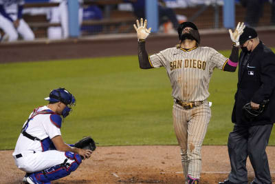 Fernando tatis jr in a padres jersey celebrating with a world