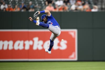 Bo Bichette of the Toronto Blue Jays leaps as he runs into home