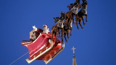 Santa Claus wears a face mask covering while waiting for children