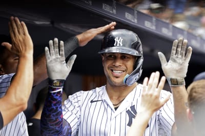 New York Yankees' Gleyber Torres (25) is congratulated by Josh Donaldson  after hitting a home run against the Boston Red Sox during the fourth  inning of a baseball game Saturday, June 10