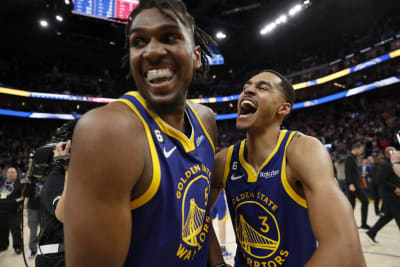 Golden State Warriors guard Kelly Oubre Jr., bottom, reaches for